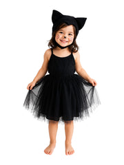 Child wearing a black cat costume with ears on a white background