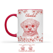 Mug with red handle featuring a dog illustration and floral patterns on a white background