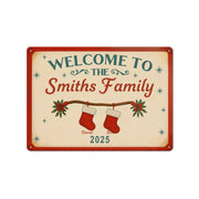 Decorative sign with 'Welcome to the Smiths Family' text and Christmas stockings on a beige background.
