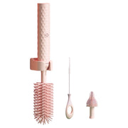 Set of pink kitchen brushes with different bristle designs on a white background